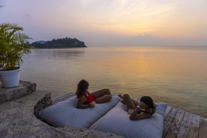 Couple relaxing at sunset in daybeds