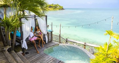Couple sitting on daybed next to plunge pool